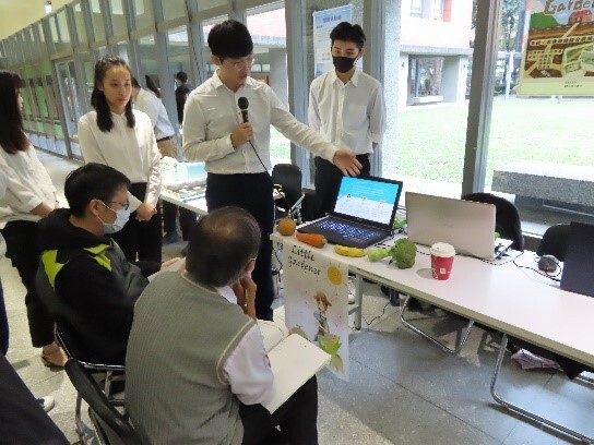 Students use laptops to showcase their work.